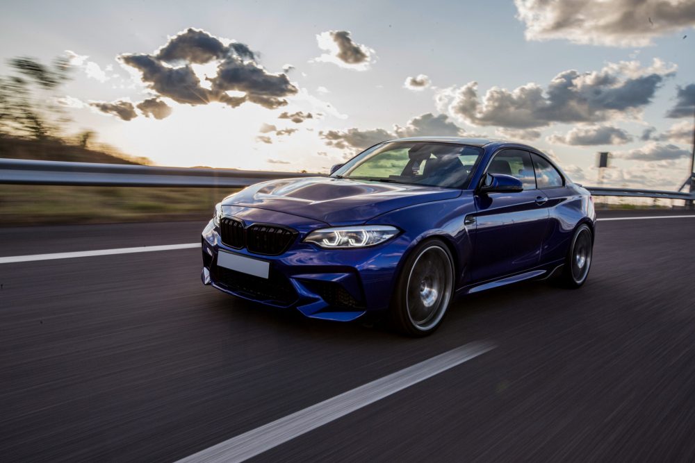blue-sedan-car-driving-road-cloudy-weather-1-e1750064299183